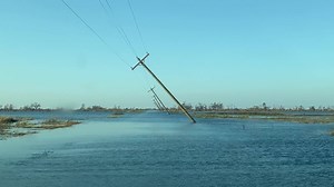 Flood waters and leaning new power poles from Hurricane Delta in Rutherford Beach, LA | Reed Timmer Extreme Meteorologist