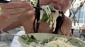 Pho soup Traditional Vietnamese pho soup with greens and chicken sprouted bean sprouts red hot pepper on the table Coconut coconut water breakfast in Vietnam