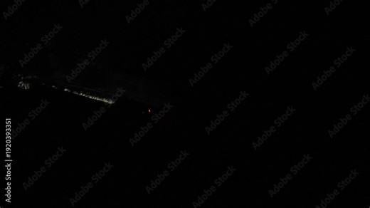 Blackout in Ukraine. Car driving on a completely dark street at night in winter with only headlights illuminating the snow