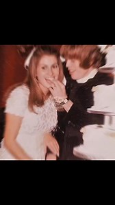 "On a crisp autumn day in 1968, British pop sensation Peter Noone, frontman of Herman’s Hermits, wed Mireille Strasser in an intimate ceremony in London. The couple, who had met just a year earlier while Mireille was working in the fashion industry, were married at a small church in the Chelsea district, surrounded by close friends and family. Peter, only 21 at the time, wore a tailored Mod-style suit, while Mireille stunned in a chic lace mini-dress with a daisy-trimmed veil—very much in step w