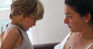 Mother scolding child misbehavior and doing pinky swear. Child promising to behave after scold