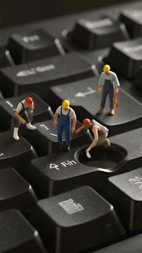 Tiny Workers Fixing a Keyboard Inside a Machine