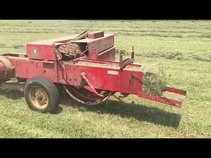 Antique number 9 Massey Ferguson square baler in the field working