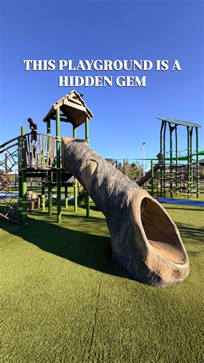 🌳✨ Today’s adventure took us to one of the cutest playgrounds around! Totally fenced-in, shaded, super clean, and made for exploring — complete with shaded spots, bathrooms changing rooms on site, and benches to chill while the little ones go wild. 💛 The playground feels like a mini outdoor storybook — with turf rolled out like the Hillsborough River flowing through, twisty tree & branch slides, climbing structures, and a big slide that was an absolute hit. 🌊🌿🛝 There is a splash pad just ad