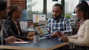 African american team of people collaborating on business strategy development, planning financial charts presentation for company growth. Job colleagues doing teamwork and collaboration with laptop.