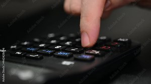 A student is doing mathematics by using electronic calculator.