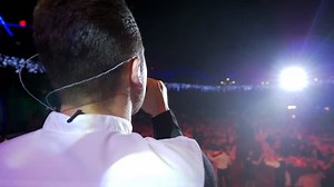 clip-1022642377-young-man-standing-on-stage-sing-song