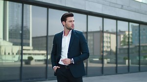 Closeup businessman standing near building at street. Man putting hand in pocket | Premium Stock Video Footage