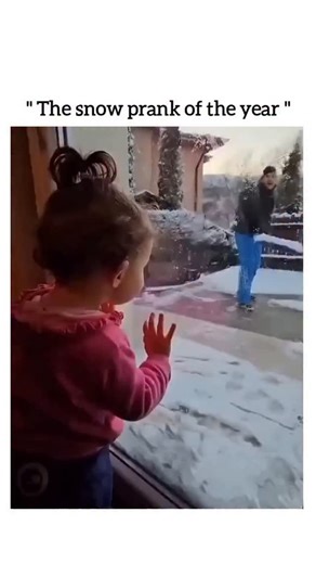 UNIVERSAL REEL HUB ™ on Instagram: "This viral reel features a playful and wintery interaction where a father playfully pranks his young daughter from outside their home. The video begins with the little girl peering curiously through a glass door at her dad, who is busy clearing snow with a large shovel. In a sudden, comedic moment, the father tosses a heap of soft snow directly against the glass, creating a harmless "splat" that momentarily obscures his face and causes the toddler to jump back