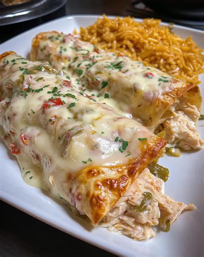 Cheesy, creamy, and full of flavor—these Queso Chicken Enchiladas are pure comfort food. Rolled tortillas stuffed with tender chicken and smothered in rich queso sauce make this recipe a family favorite every time. .............. Full Recipe in Coʍmеոτ 💬 | Nora’s Kitchen