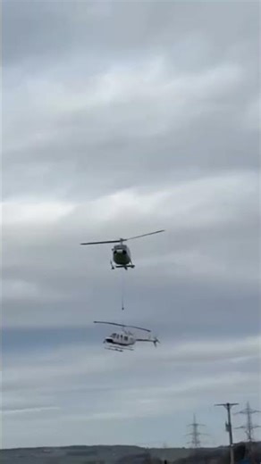 Aerial hoisting operation site: A Bell 212 helicopter is hoisting a dismantled