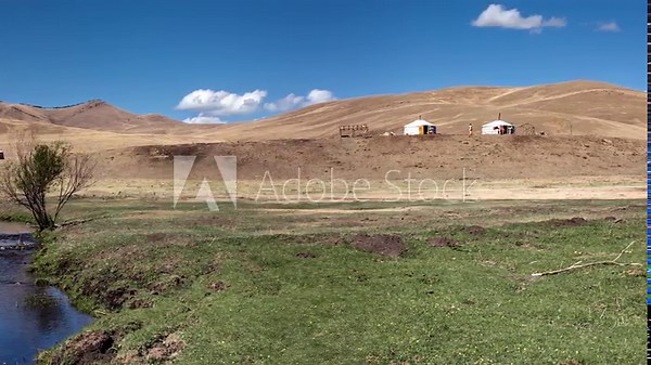 Mongolia, Tov province, panoramic view of dry steppe, 3 nomad family yurts in grassland, hill and river