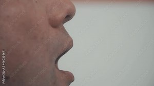 Hands in medical gloves take a swab from a man's mouth for analysis, PCR diagnostics of infections