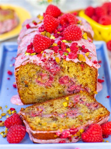 The most delicious raspberry bread loaf recipe! Easy raspberry pistachio bread with a raspberry glaze – moist, tender bread dotted with berries and crunchy bits of salted pistachios! The glaze is made with freeze-dried raspberries, which add tons of fruity flavor. I love to enjoy a slice of this bread in the morning with a cup of coffee or tea for breakfast. Make a double batch because this raspberry bread will be gone in no time! Get all the recipe details and watch my full-length YouTube video