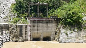 Detail footage of the civil engineering components of a dam intake showing the sluice gates and concrete pillars used to control water volume during the monsoon season. Stock Video