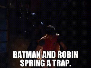 Batman and Robin spring a trap.