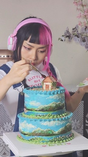 LinLin Cake 🍰 リンリンケーキ 🇲🇾 on Instagram: "Painting Howls Moving Castle scenery on a cake 💖 If you followed me much earlier, you might know that this is actually not my first time painting this iconic scene on a cake. However, it is my first time creating a big double tier with the cabin on top so i really wanted to properly film the process 😊 it may look easy or simple but all the long hours building & layering the colors are all edited into under a minute. You see, this cake shop has always