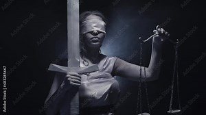 Greek goddess Themis stands on black background with moving smoke in white clothes. Blindfolded woman holds a sword in her hand and lifts a scale. Studio. Closeup. Concept of Greek mythology