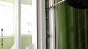 The hardware of the window sash is adjusted using a screwdriver. Maintenance of metal-plastic windows.