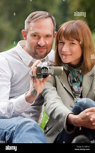 woman romantic video film movie video camera couple pair man woman laugh laughs Stock Photo - Alamy