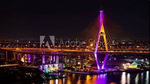 time lapse of Bhumibol suspension bridge cross over Chao Phraya River at night in Bangkok city, Thailand