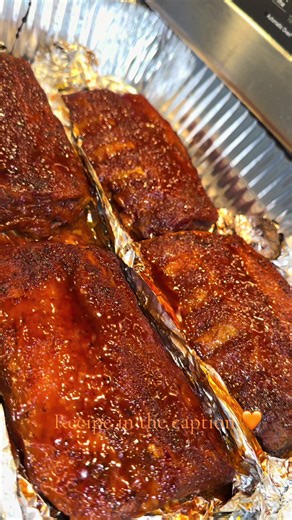 Clean your ribs and pull that membrane off (I’ve got a full video on my page showing how to do it). Pat them dry, then hit them with some mustard and mix it in really well. Add a splash of liquid smoke, Worcestershire sauce, and a little apple cider vinegar. Mix until every part is coated. Now season those ribs to perfection. Use whatever seasonings you love, but don’t skip the brown sugar. Press the seasoning in — don’t rub it. Make sure you season both sides. Wrap the ribs in foil twice, and l