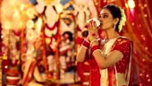Bengali woman blowing conch shell in durga puja festival, Delhi, India