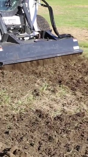 This bi-directional Rotary Tiller from Haugen will become your new favorite attachment as it enables tilling both forwards and backwards. The best way to go is to run the attachment forward a few times to break up the soil and make the final pass backward to ensure a smooth finish without visible tire marks. #skidsteer #skidsteerattachment #landscaping #rotarytiller #rototiller #skidsteersolutions #haugen | Skid Steer Solutions