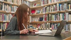 Calm Caucasian brunette girl with glasses student listening to online webinar lesson, taking notes with pencil, studying foreign language on laptop, doing math homework, teacher preparation e-learning Stock Video