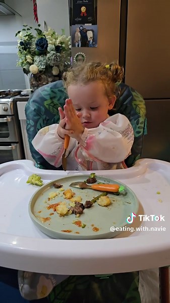 Baby loves fresh veggies: toddler enjoys tomato and homemade meal