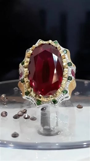 Luxurious Ring with Red Gemstone and Intricate Design