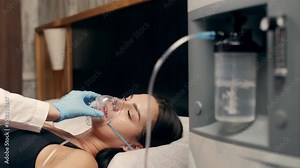 Portrait of a sick young woman who uses an oxygen concentrator and an inhaler for treatment at home. covid-19, bronchial asthma. Treatment, treatment and procedures, therapy.