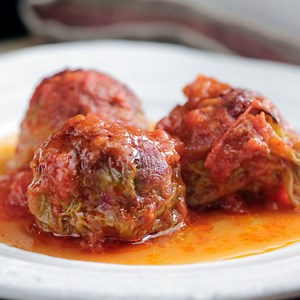 This old-school dish of meatballs wrapped in cabbage and topped with a light tomato sauce is perfect for cold nights in. | Tastemade