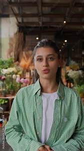 The girl working at the flower store provides insights into her role as a florist.