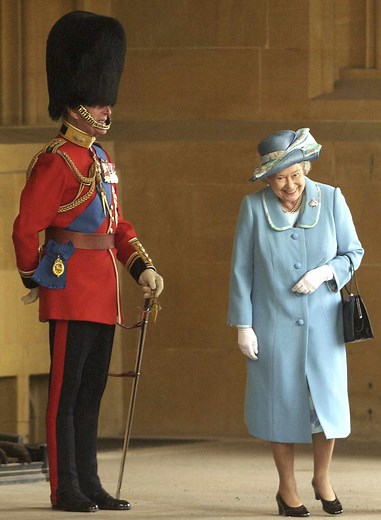 The Real Story Behind the Viral Photo of Queen Elizabeth Giggling Next to Prince Philip in Uniform
