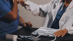 Download A doctor is checking the pulse of a patient for free