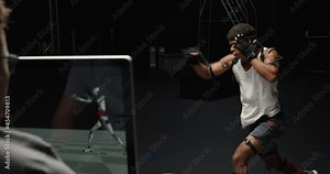 man wearing motion capture suit in studio performing martial arts actor boxing wearing mo-cap suit for 3d character computer game animation for virtual reality fighting gaming