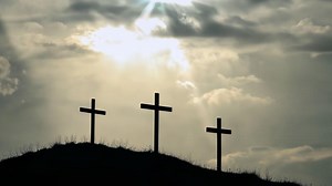 Download Silhouette of three crosses on hill against dramatic sky for free