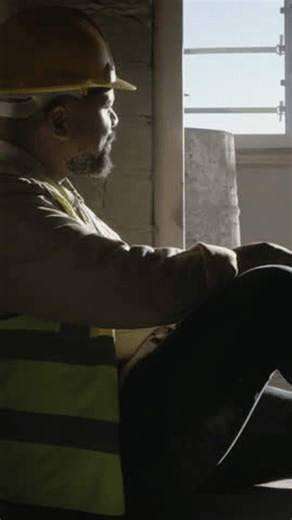 clip-3986887627-thinking-construction-helmet-man-on-site-building