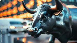 A close-up of a glossy bronze bull statue symbolizes financial strength and market optimism against a blurred urban backdrop, capturing the essence of economic growth and city vibrancy.