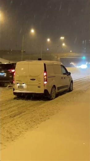 Vans stuck in the snow on Yonge Street in Toronto