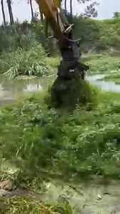 Operator of a machine easily cleaning a pond of vegetables | Machinery Magazine