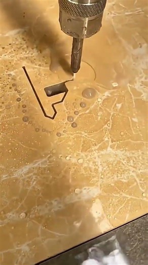 Waterjet cutting machine shaping a marble slab