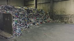 Wide shot of a large pile of mixed waste materials ready for...