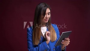 Closeup portrait of attractive caucasian female flipping images on the tablet and reacting in different ways