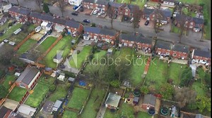 Tilting aerial generic view of a British housing estate of houses