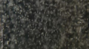 Glass of water with aspirin white tab. Sparkling Bubbles in glass of water. Effervescent tablet falls on a bottom of a glass