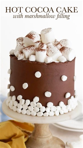HOT COCOA CAKE 🤎 turns out that making homemade marshmallow creme filling is SO MUCH BETTER than the store bought stuff and the perfect addition to this hot cocoa flavored cake. There’s hot cocoa mix in the cake layers buttercream for that nostalgic mug of cocoa flavor profile, and paired with the marshmallow filling this cake is totally irresistable. The full recipe decorating tutorial is linked in my bio and at https://sugarandsparrow.com/hot-cocoa-cake-recipe/ #hotcocoa #chocolatecake #marsh