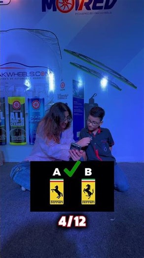 Can you guess the car logo before this child?