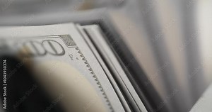 Banknote counter machine counts dollars in company office slow motion. Specialized tool suitable for quick operations with cash for secure transactions